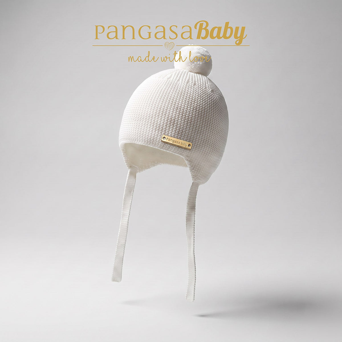 GORRO OREJERO BEBE PUNTO CON POMPON PUNTO MARFIL